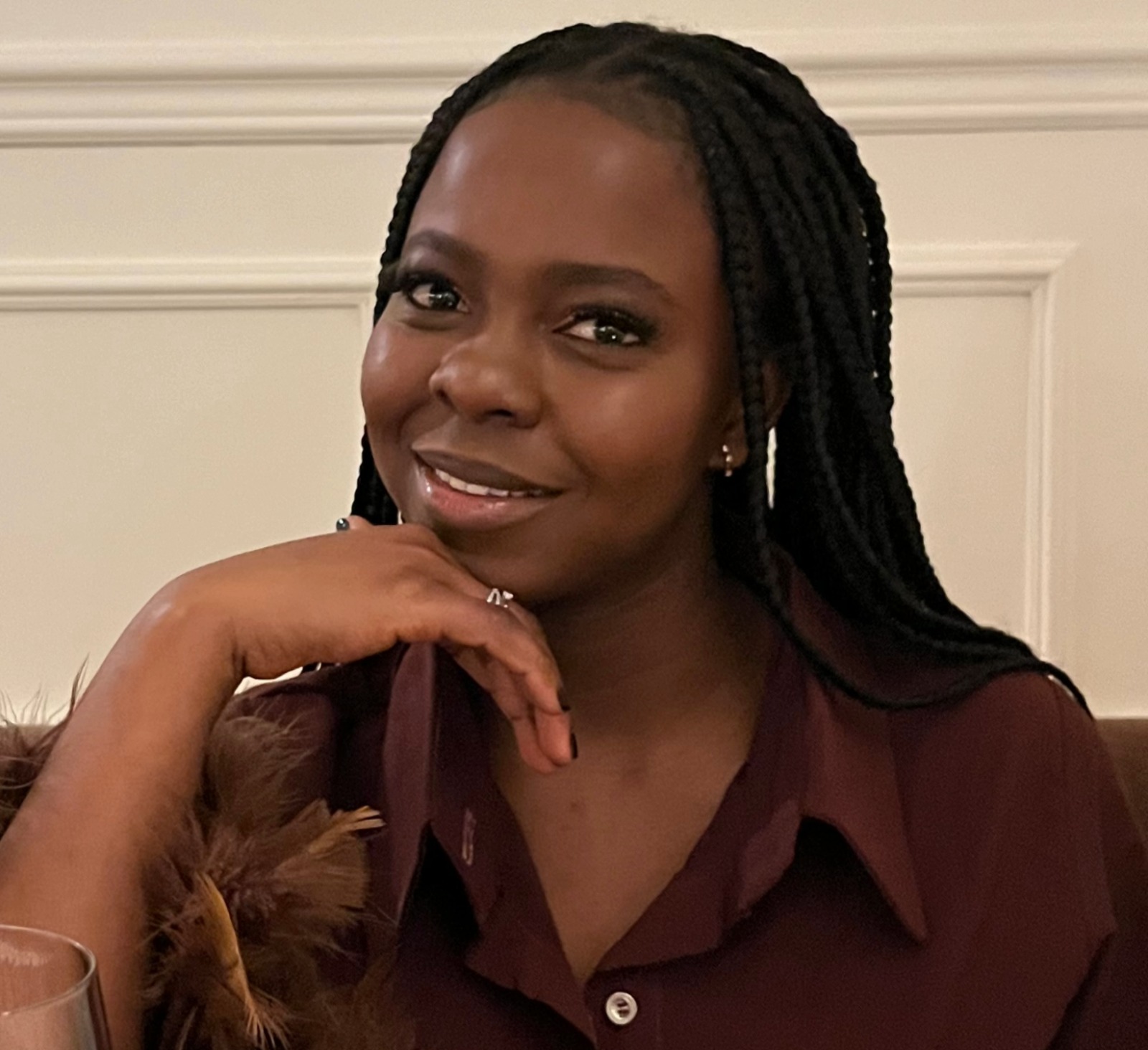 Silvia Owusu-Agyeman smiling in a warm burgundy blouse